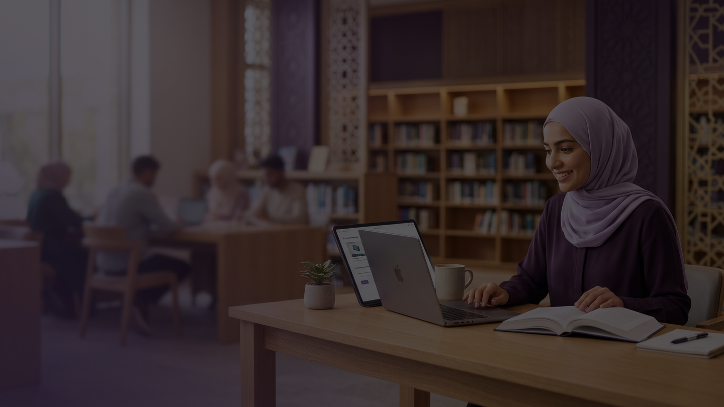 Muslim educator using ILM Fusion on a laptop in a school library.